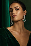 Model in emerald velvet wearing emerald drop earrings