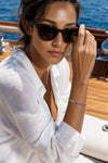 Rainbow sapphire tennis bracelet on a yacht deck