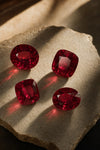 Pigeon-blood rubies on warm limestone