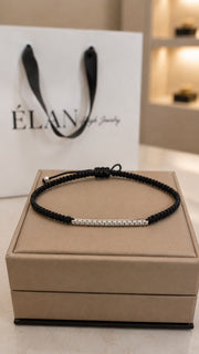 Diamond Bar Cord Bracelet in black on the Maison ÉLAN box