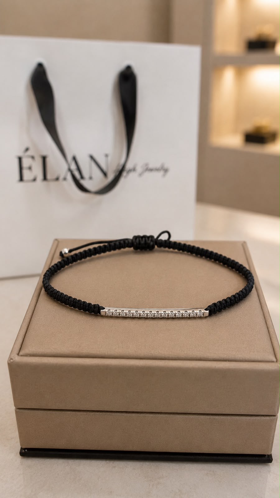 Diamond Bar Cord Bracelet in black on the Maison ÉLAN box